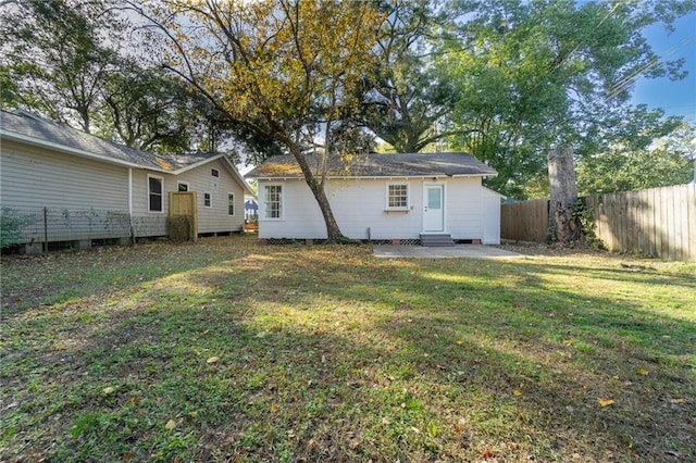 rear view of house featuring a yard