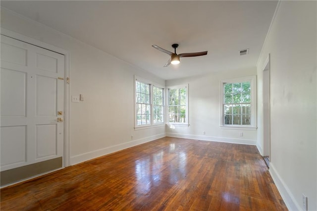 spare room featuring dark hardwood / wood-style flooring and ceiling fan