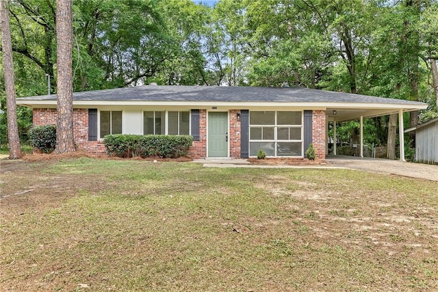 ranch-style home with a carport, driveway, a front lawn, and brick siding