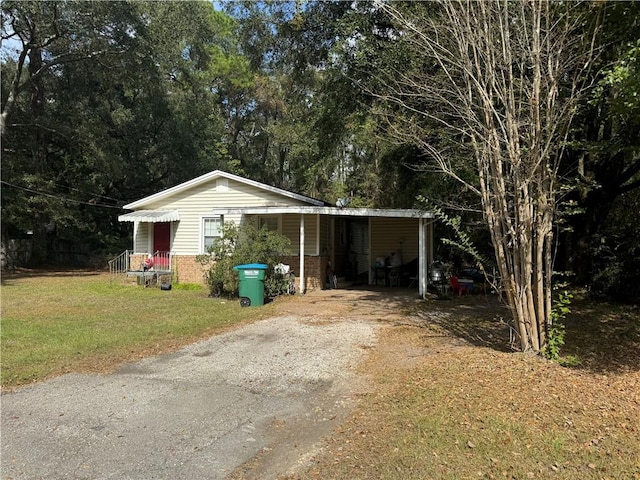 view of outbuilding with a carport and a yard