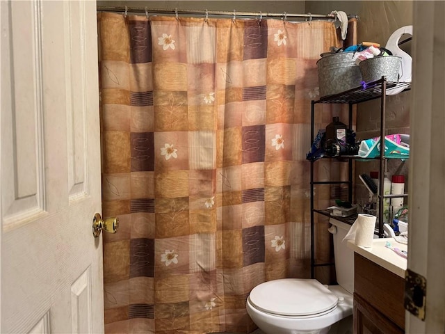 bathroom with vanity, curtained shower, and toilet