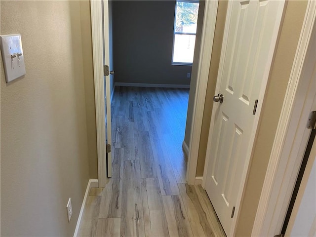 corridor with light hardwood / wood-style flooring