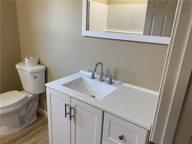 bathroom featuring hardwood / wood-style flooring, vanity, and toilet