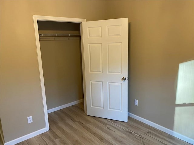 unfurnished bedroom featuring a closet and light hardwood / wood-style flooring