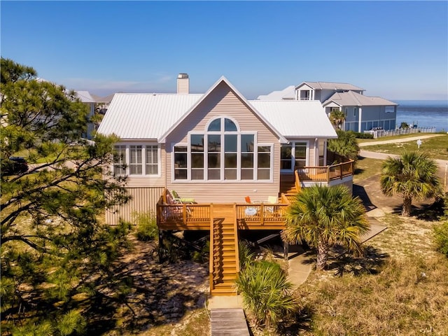 back of house with a deck with water view