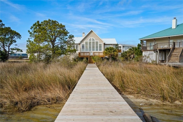 rear view of property with a water view