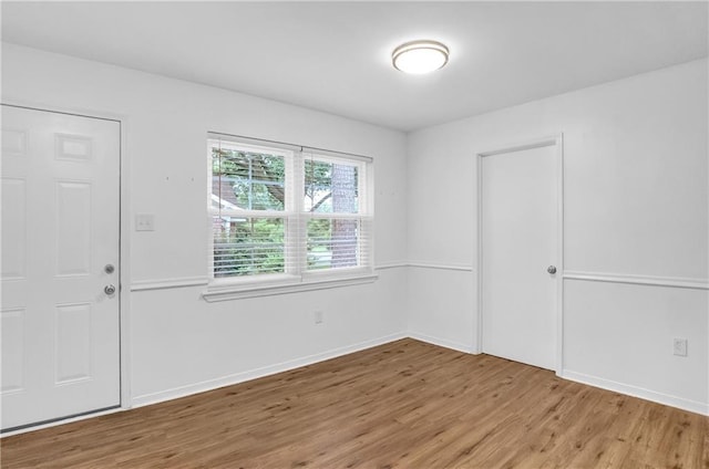 foyer entrance featuring light wood-style flooring and baseboards
