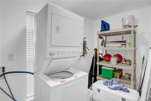 laundry room with stacked washer and clothes dryer and laundry area