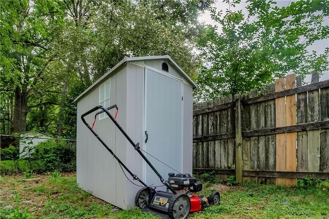 view of shed featuring fence