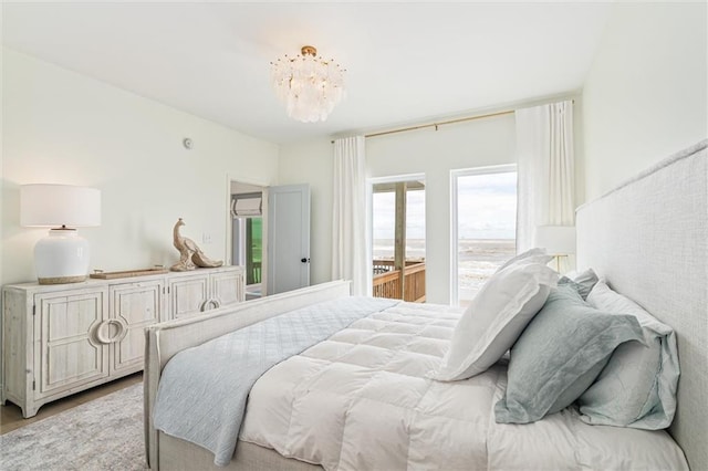 bedroom with light wood-type flooring and a chandelier