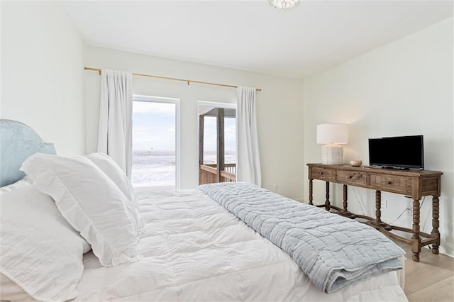 bedroom featuring access to outside and light hardwood / wood-style floors