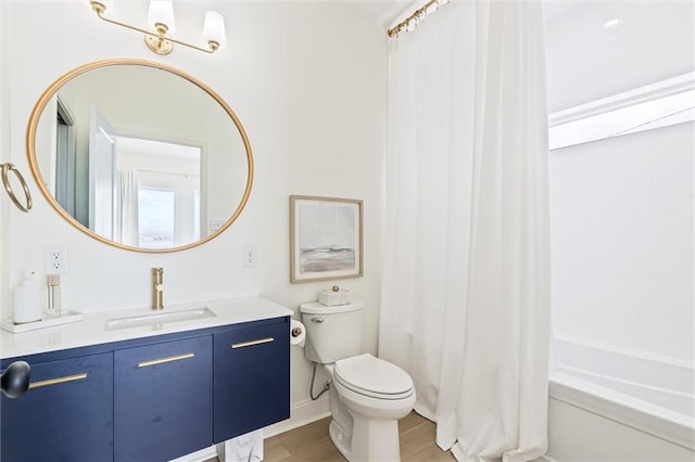 full bathroom featuring toilet, vanity, shower / bath combo with shower curtain, and hardwood / wood-style flooring