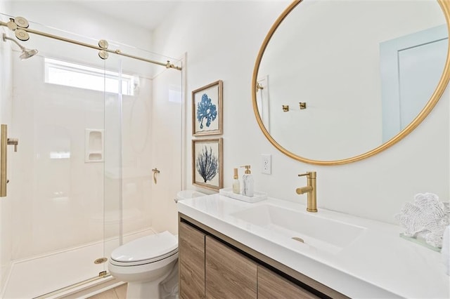 bathroom with a shower with door, vanity, toilet, and tile patterned floors