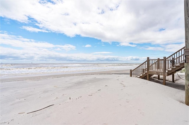 surrounding community featuring a beach view and a water view