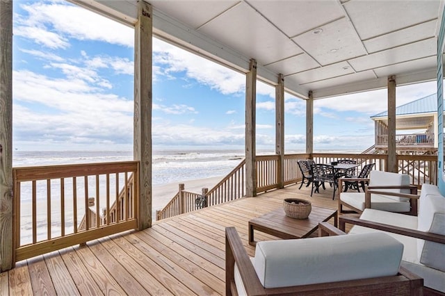 deck with a beach view and a water view