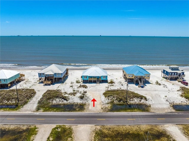 birds eye view of property with a view of the beach and a water view