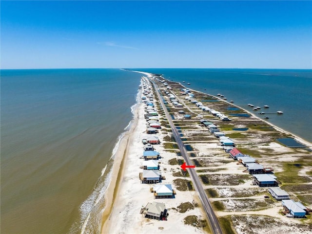 drone / aerial view with a water view and a beach view