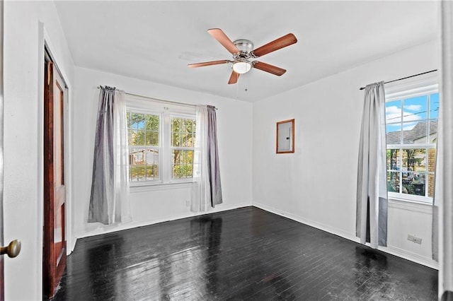 empty room with dark hardwood / wood-style floors and ceiling fan