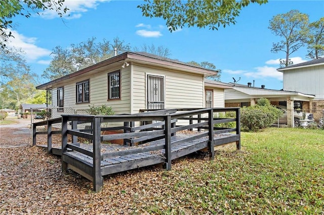 view of home's exterior featuring a lawn and a wooden deck