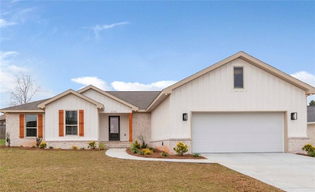 view of front of house featuring a front lawn, brick siding, concrete driveway, and an attached garage