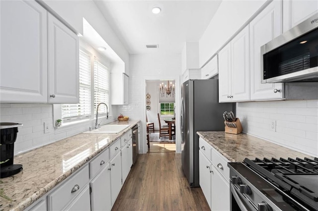1910 Hunter Ave, Mobile, AL 36606 - kitchen featuring stainless steel appliances, a sink, a chandelier, and white cabinets