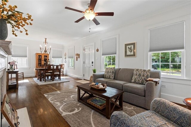 1910 Hunter Ave, Mobile, AL 36606 - living room featuring a chandelier, a ceiling fan, dark wood-style floors, crown molding, and baseboards