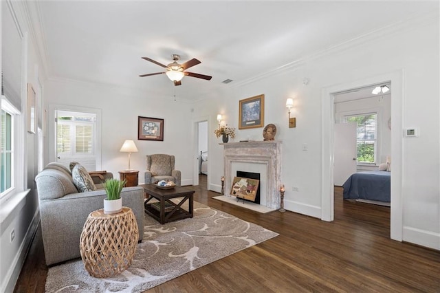 1910 Hunter Ave, Mobile, AL 36606 - living area with wood finished floors, a ceiling fan, ornamental molding, baseboards, and a fireplace with flush hearth