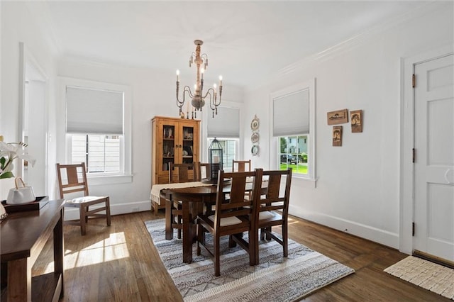 1910 Hunter Ave, Mobile, AL 36606 - dining room featuring a chandelier, healthy amount of natural light, crown molding, baseboards, and dark wood-type flooring