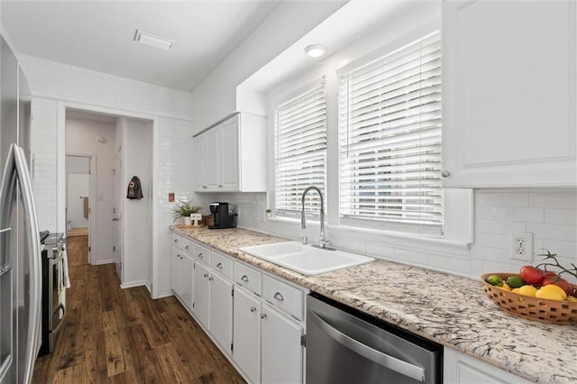 1910 Hunter Ave, Mobile, AL 36606 - kitchen with stainless steel appliances, a sink, white cabinetry, and tasteful backsplash