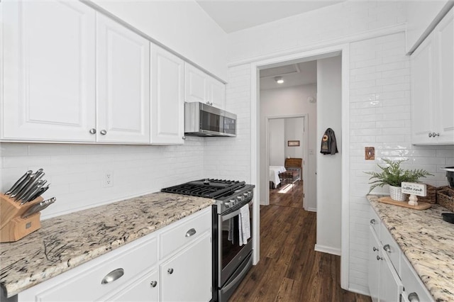 1910 Hunter Ave, Mobile, AL 36606 - kitchen with stainless steel appliances, tasteful backsplash, white cabinets, and dark wood-style floors