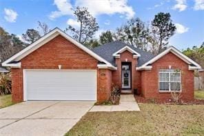 1521 Peyton Dr E, Mobile, AL 36695 - view of front of property with concrete driveway, a garage, and a front yard