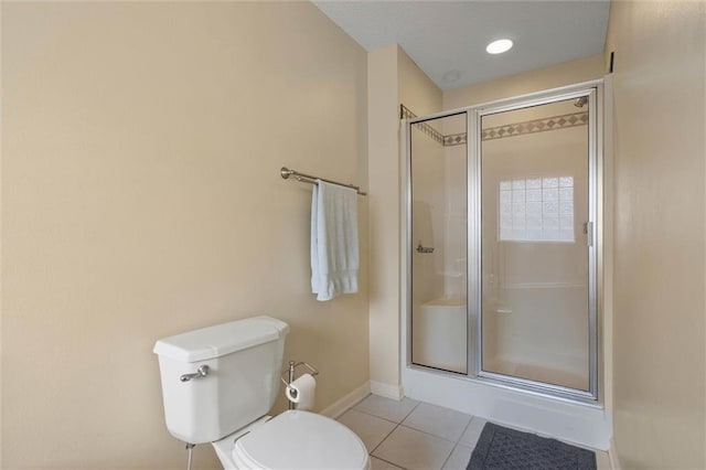 1521 Peyton Dr E, Mobile, AL 36695 - bathroom featuring a stall shower, toilet, tile patterned floors, and baseboards