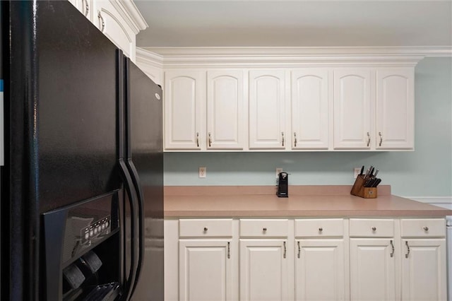 1521 Peyton Dr E, Mobile, AL 36695 - kitchen with black fridge, light countertops, and white cabinetry