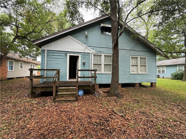 back of house with a wooden deck