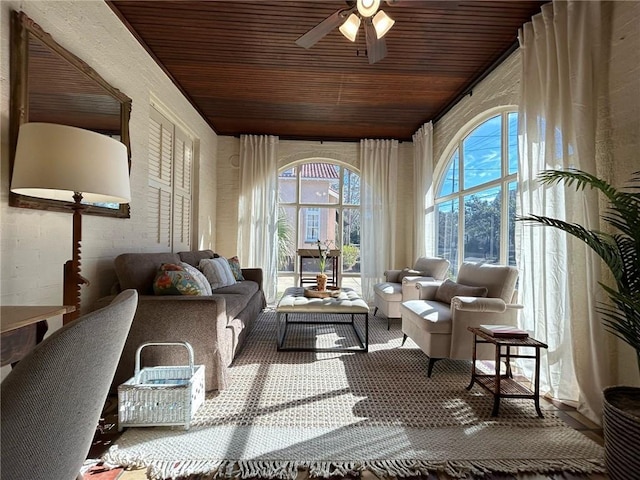 sunroom with ceiling fan and wood ceiling