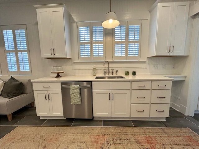 kitchen with white cabinetry, sink, dark tile patterned floors, and dishwasher