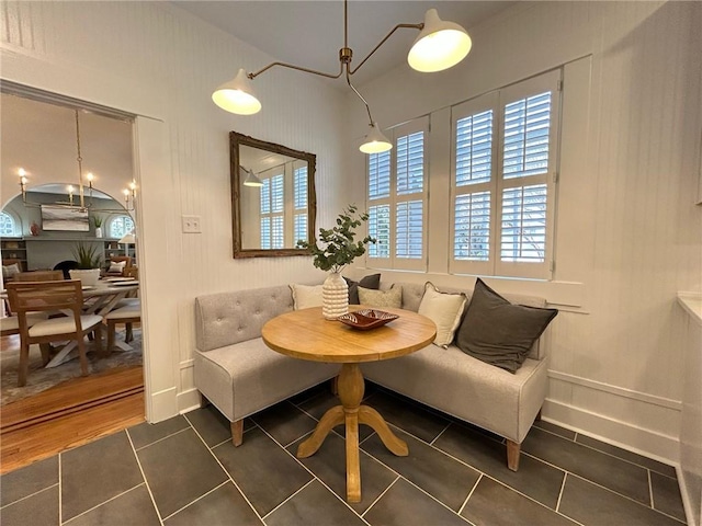 living area featuring breakfast area and dark tile patterned flooring