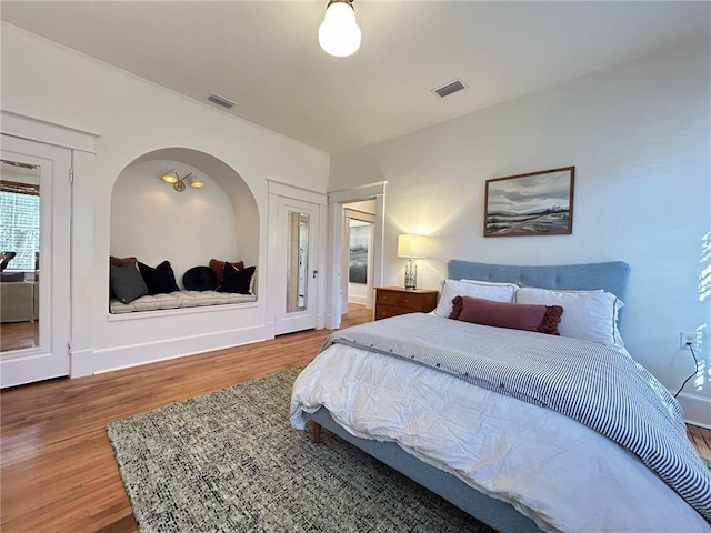 bedroom with wood-type flooring