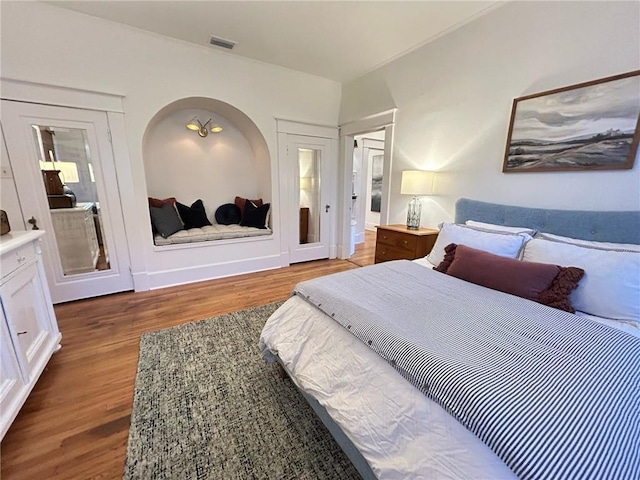 bedroom with dark wood-type flooring