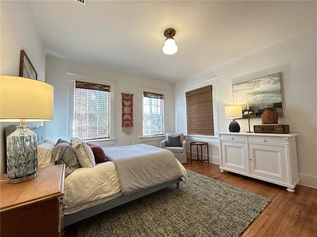 bedroom with dark hardwood / wood-style floors