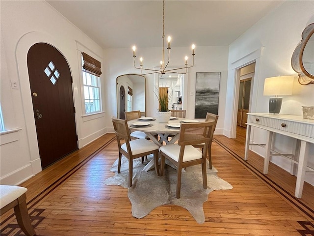 dining area with an inviting chandelier and light wood-type flooring