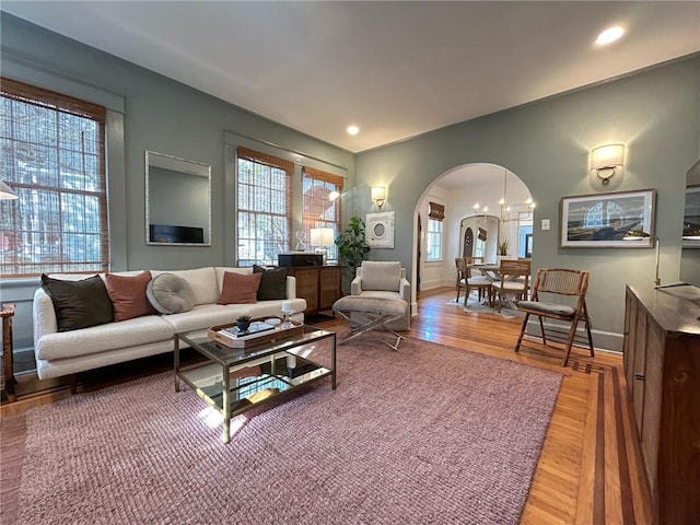 living room with hardwood / wood-style flooring and a chandelier