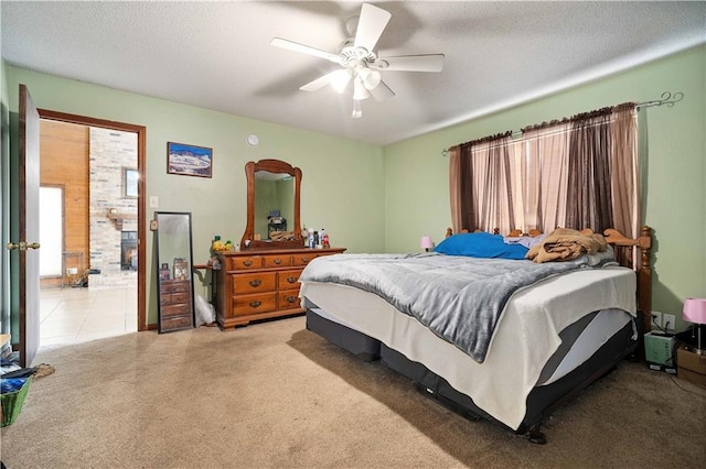 carpeted bedroom with ceiling fan and a textured ceiling