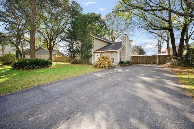 view of side of home with a lawn