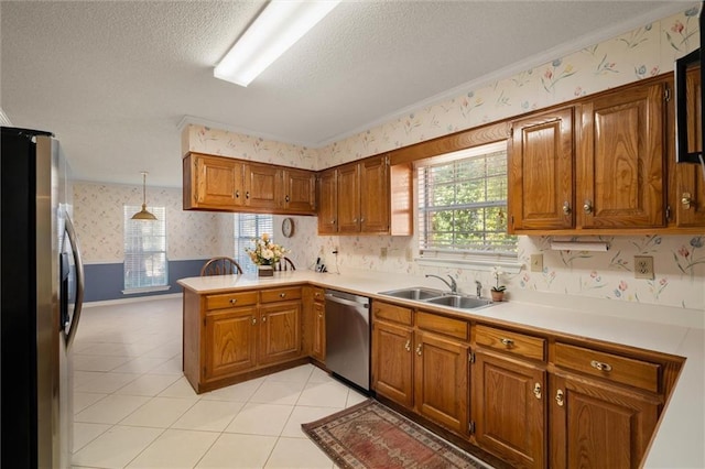 kitchen with sink, hanging light fixtures, stainless steel appliances, light tile patterned flooring, and kitchen peninsula