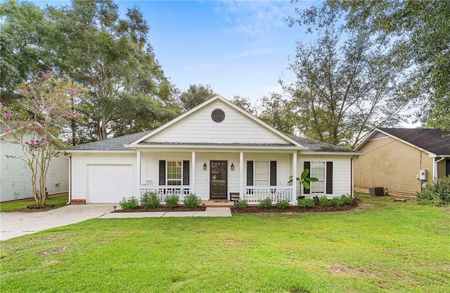 view of front of home with a garage, a front lawn, central AC unit, and a porch