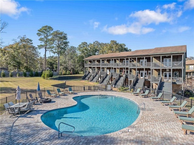 view of swimming pool with a yard and a patio