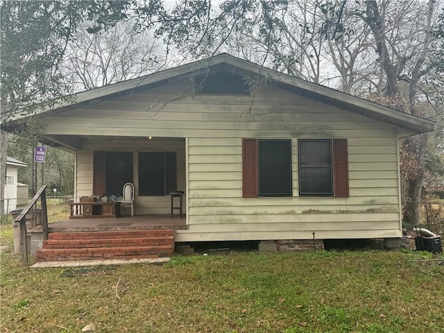 back of house with a lawn