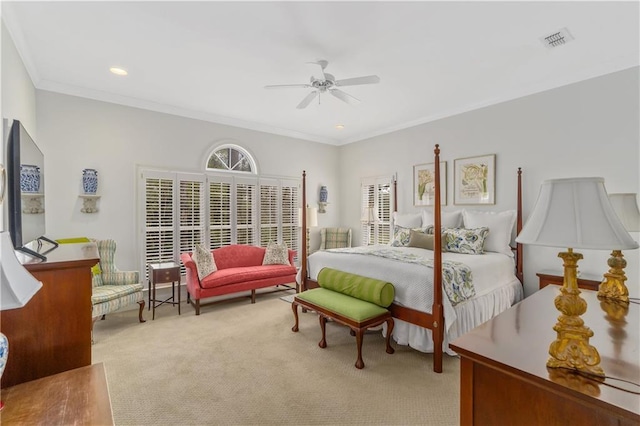 carpeted bedroom with ornamental molding and a ceiling fan