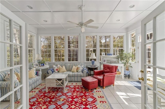sunroom / solarium featuring tile patterned flooring and coffered ceiling